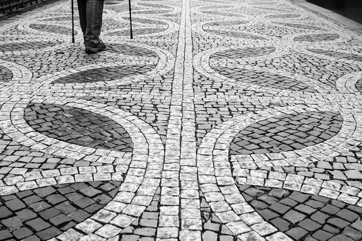 Schwarz-Weiß-Fotografie mit grafischen Mustern und Linien im Pflaster