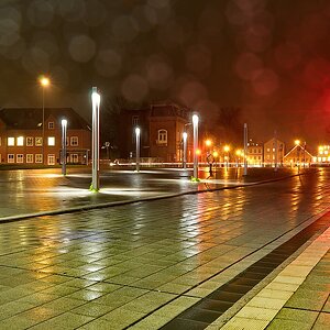 Großer Platz in der Nacht bei Nieselregen