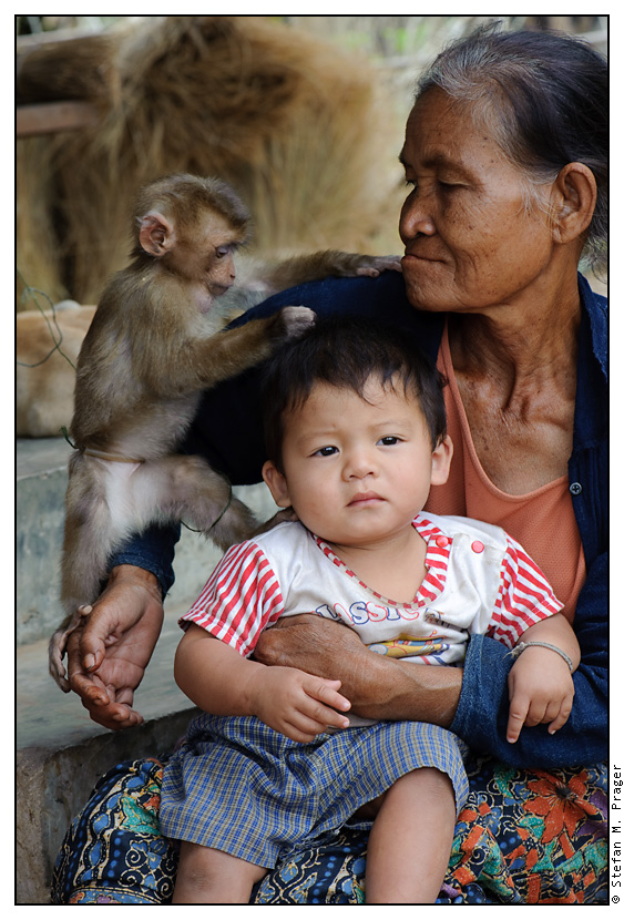 Grossmutter mit Enkelkind und Affe auf Don Det (Si Phan Don), Laos