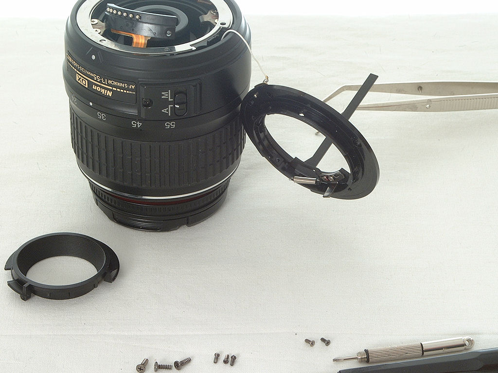 Tausch des Kunststoff-Bajonetts an einem AF-S DX Nikkor:
6.) den Blendenmechanik-Ring in das neue Bajonett einsetzen und die Zugfeder einhängen.
Links